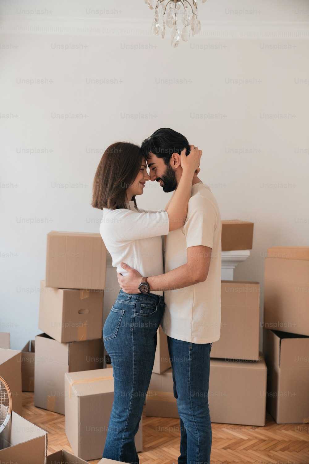 a man and a woman hugging in front of boxes