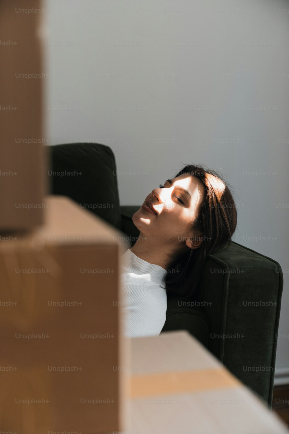 a woman laying on a couch with her eyes closed