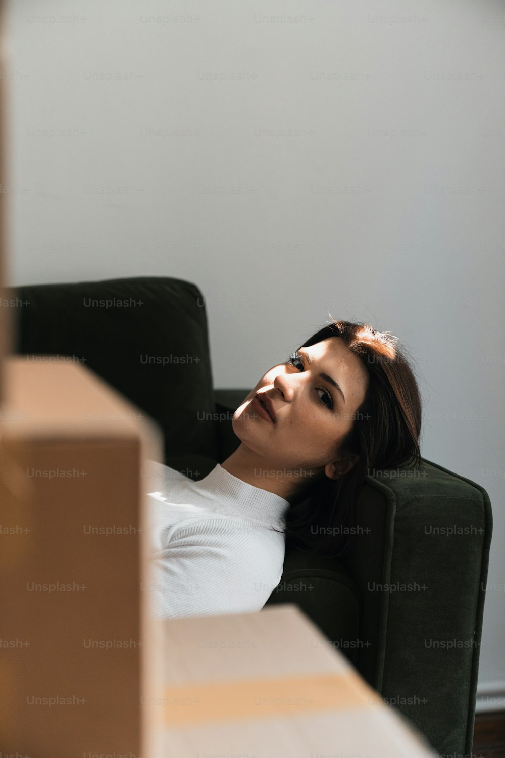 a woman sitting in a chair with her eyes closed