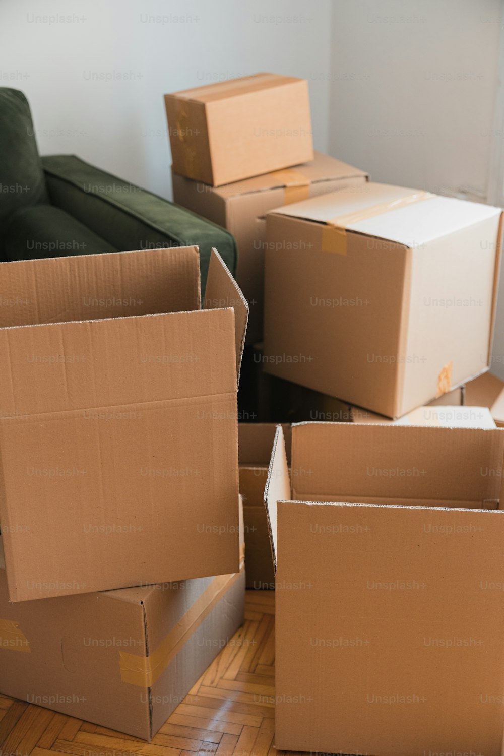 a pile of boxes sitting on top of a hard wood floor