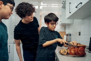 a young boy cutting a cake with a knife