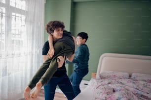 a woman holding a man in a bedroom
