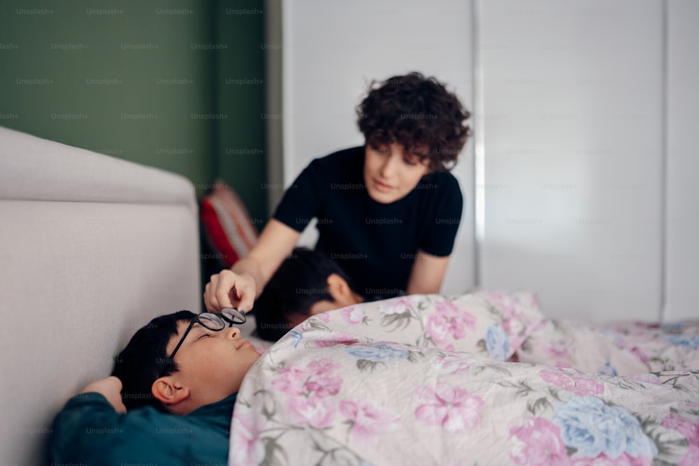 a man laying on a bed next to a woman