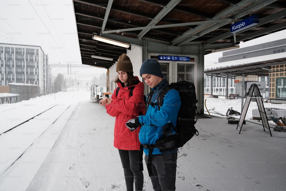 a couple of people that are standing in the snow