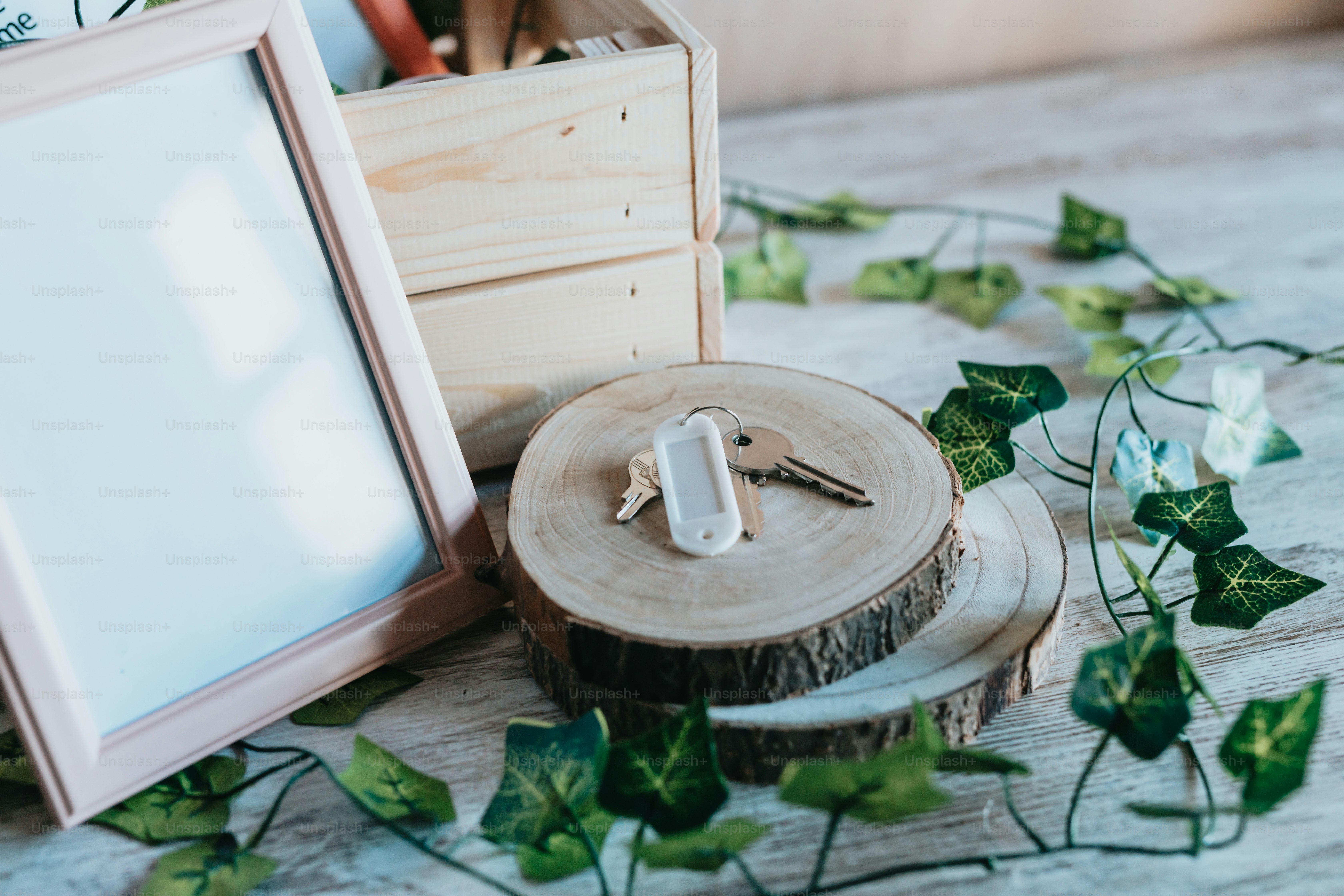 a picture frame, keys, and a box on a table