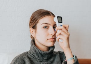 a woman holding a cell phone up to her face