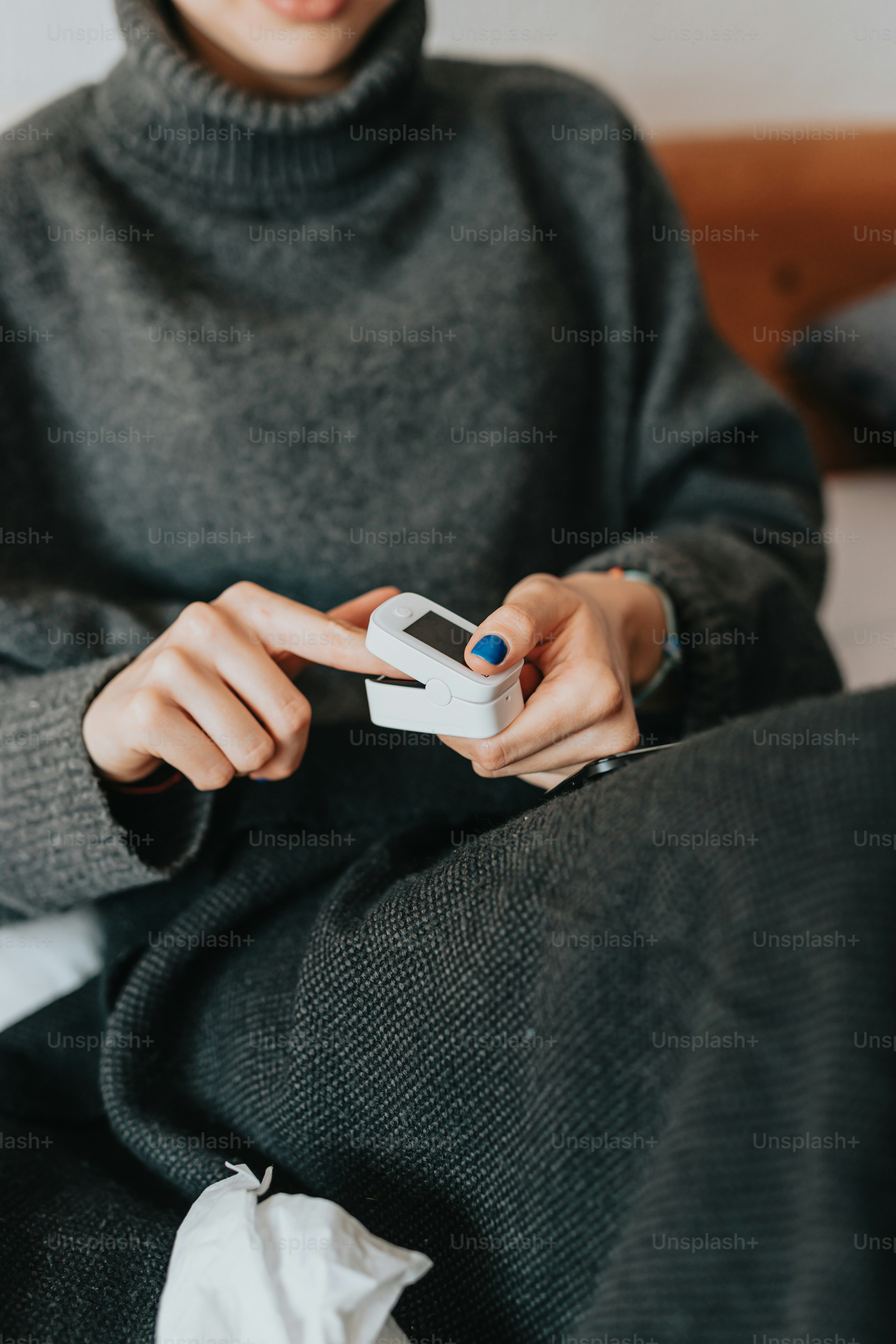 a woman sitting on a bed holding a remote control