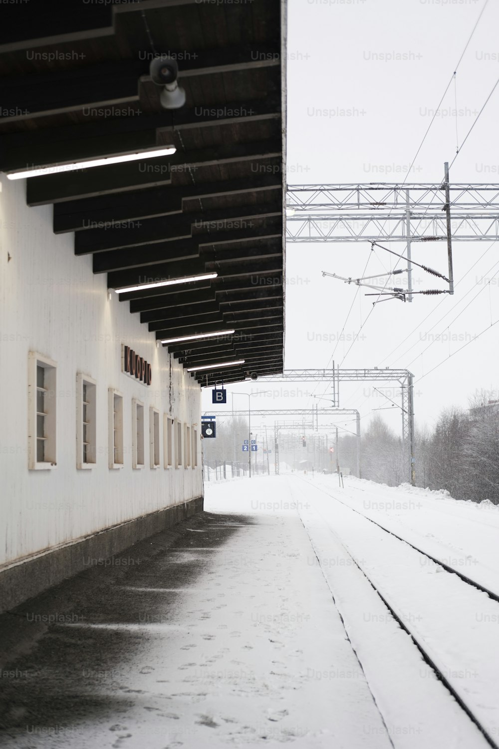 a train station with snow on the ground