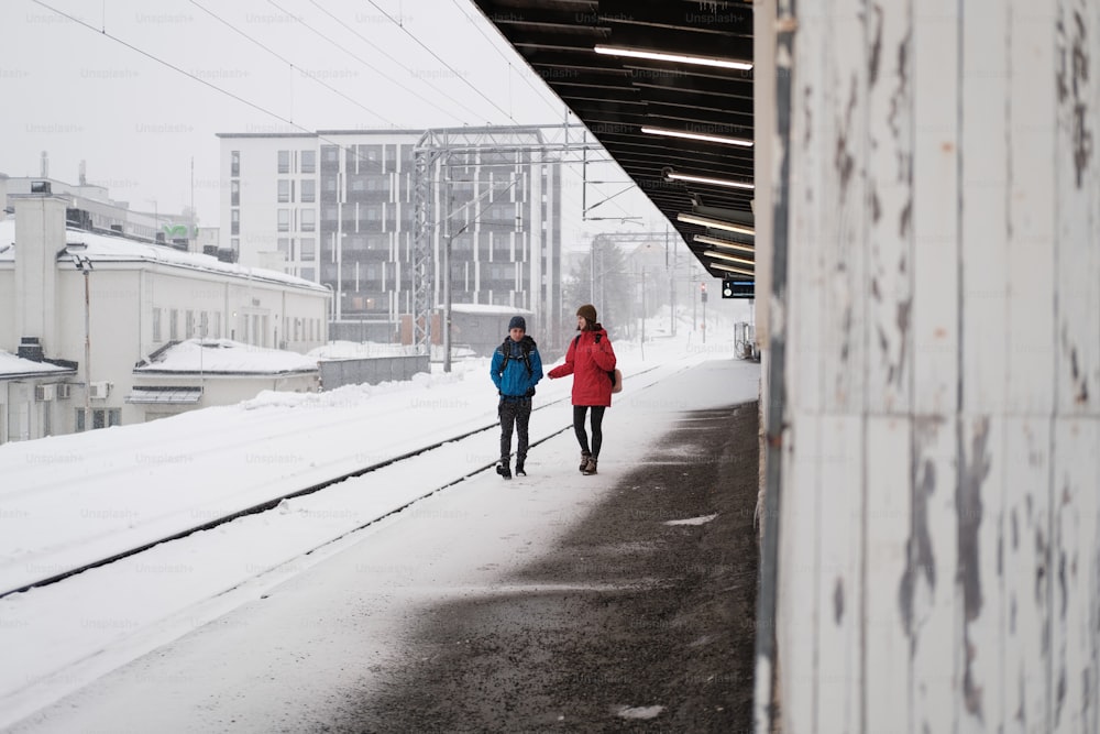 雪に覆われた歩道を歩く数人の女性