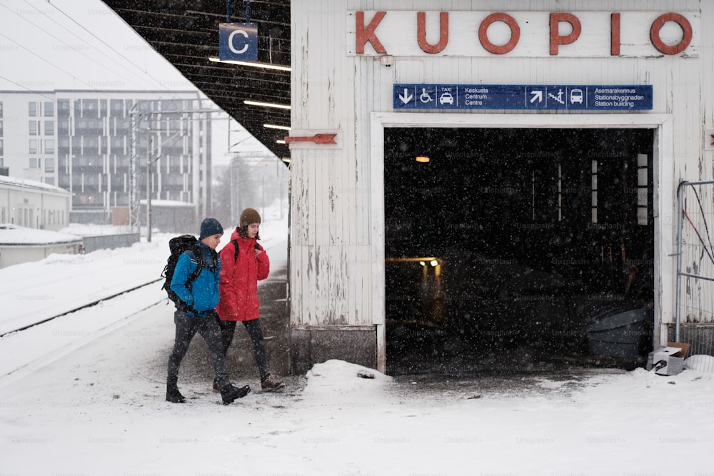 a couple of people that are walking in the snow