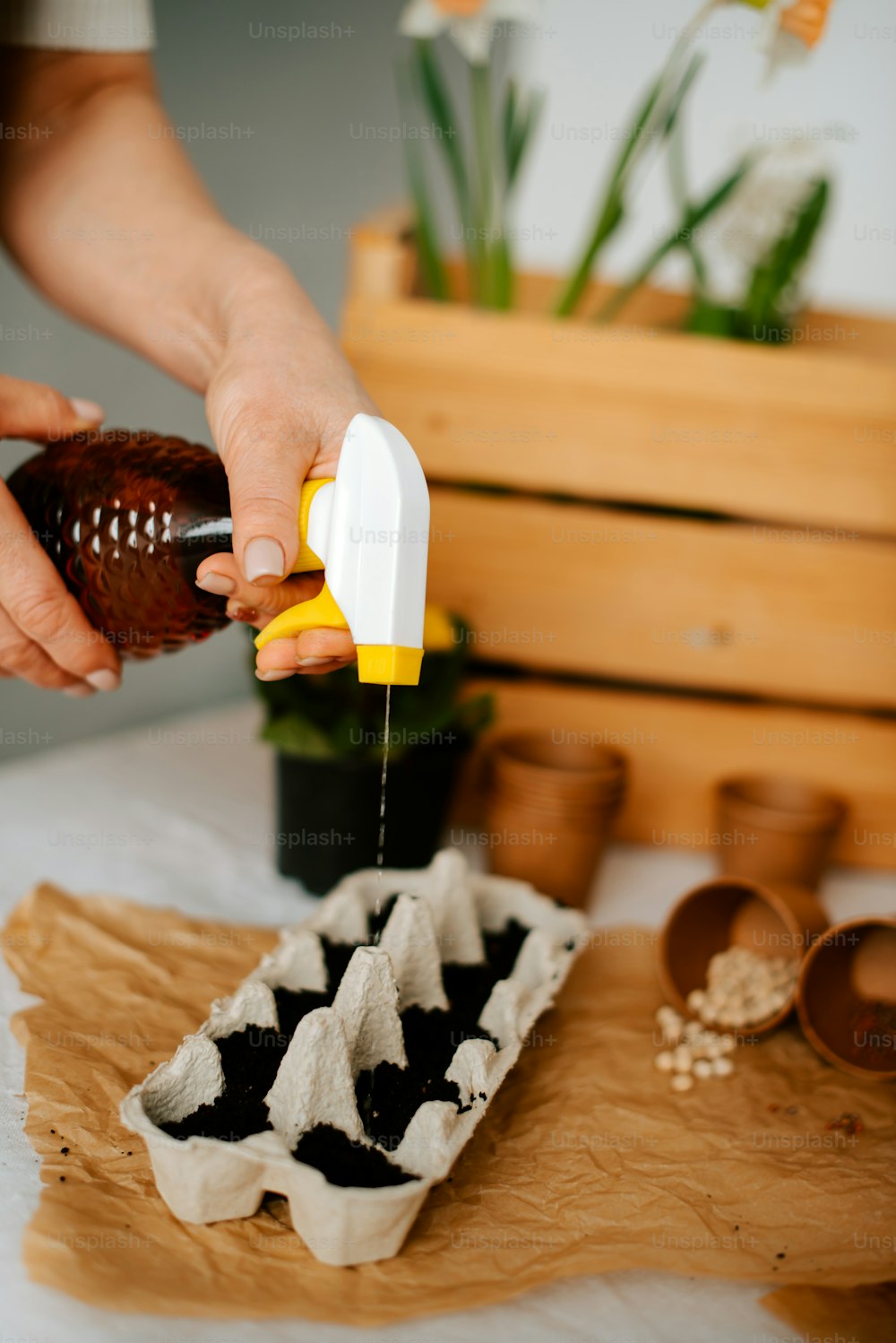 a person is sprinkling a chocolate egg with a yellow and white sprin