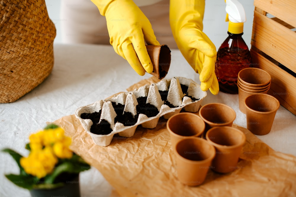 a person in yellow gloves is decorating a tray of food