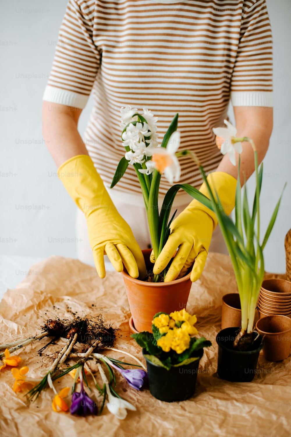 une personne portant des gants jaunes et des gants de jardinage