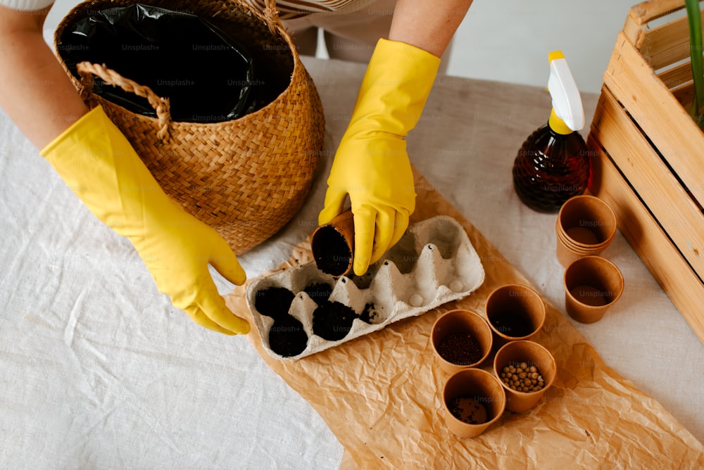 a person in yellow gloves and yellow gloves is putting something in a tray