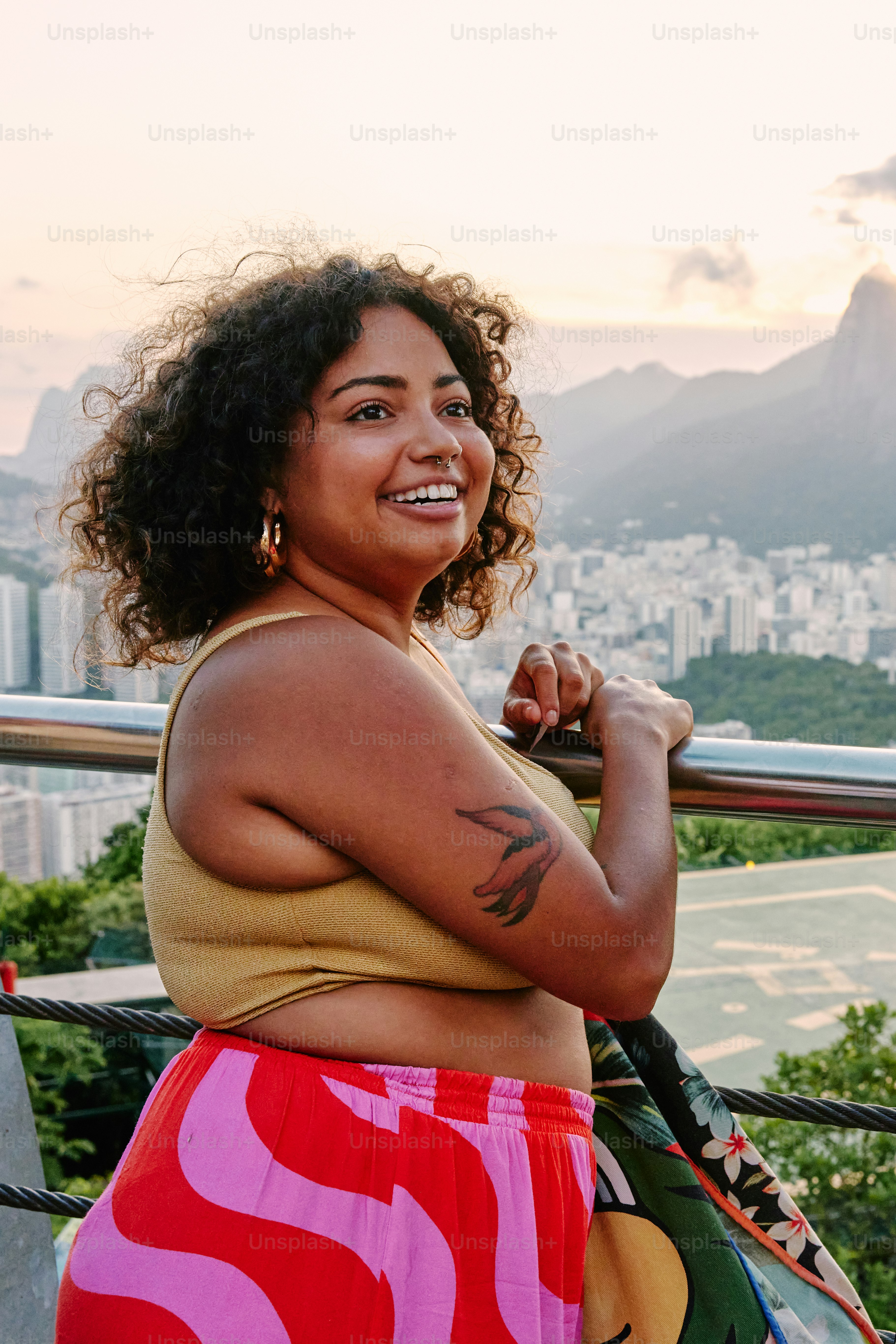 a woman with a tattoo on her arm posing for a picture