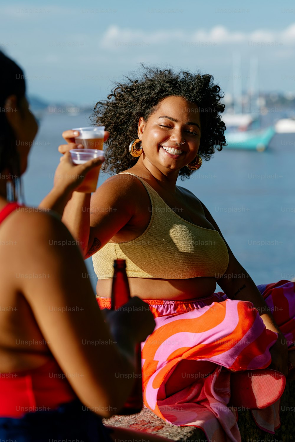 a woman sitting on a bench holding a glass of wine