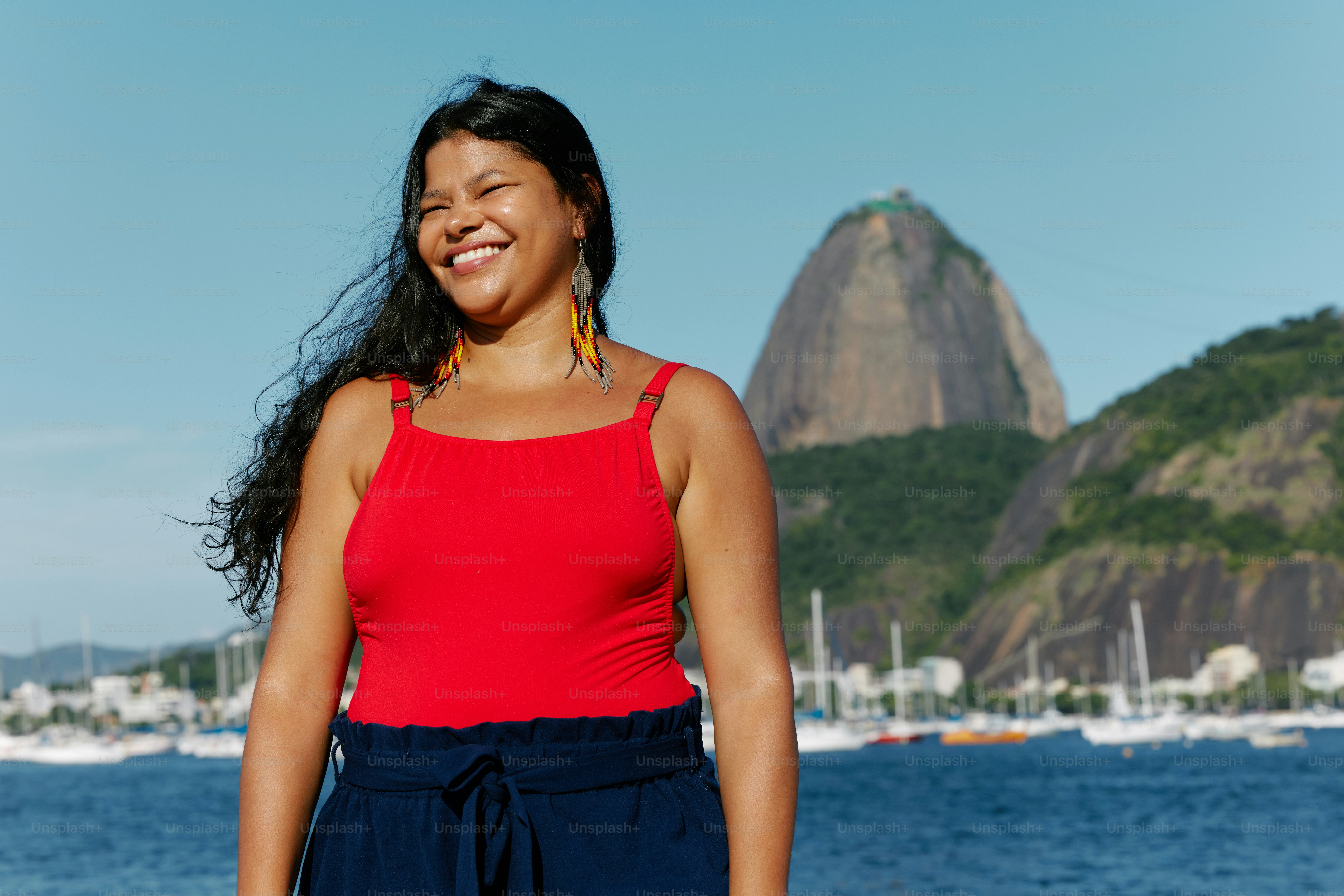 a woman standing in front of a body of water