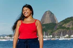 a woman standing in front of a body of water