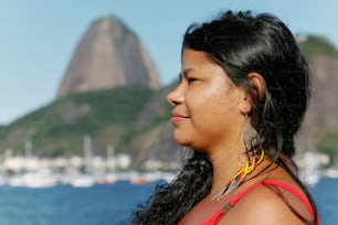 a woman standing in front of a body of water