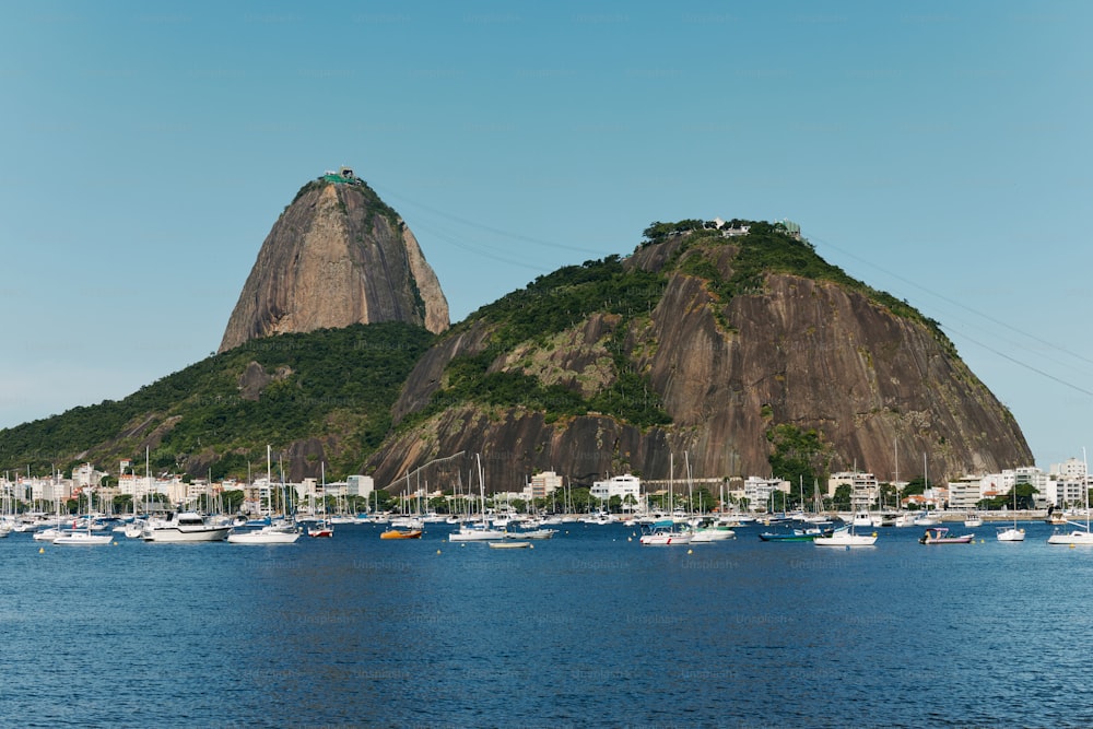 a large body of water with a mountain in the background