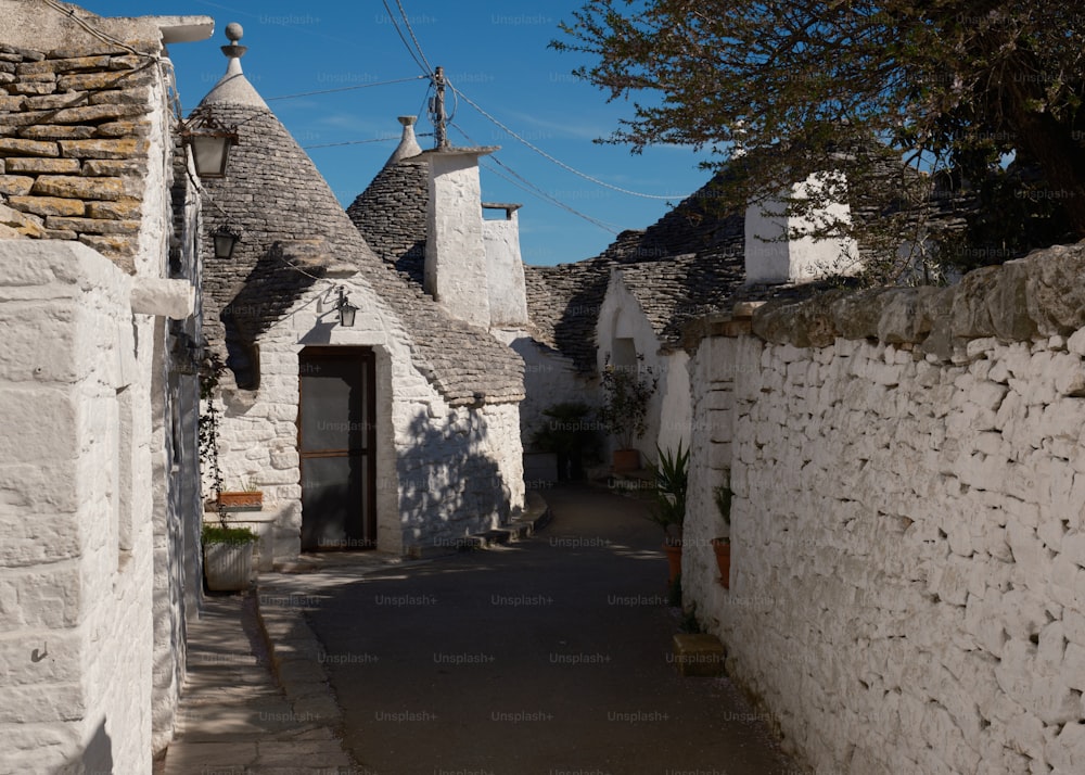a narrow street lined with white stone buildings