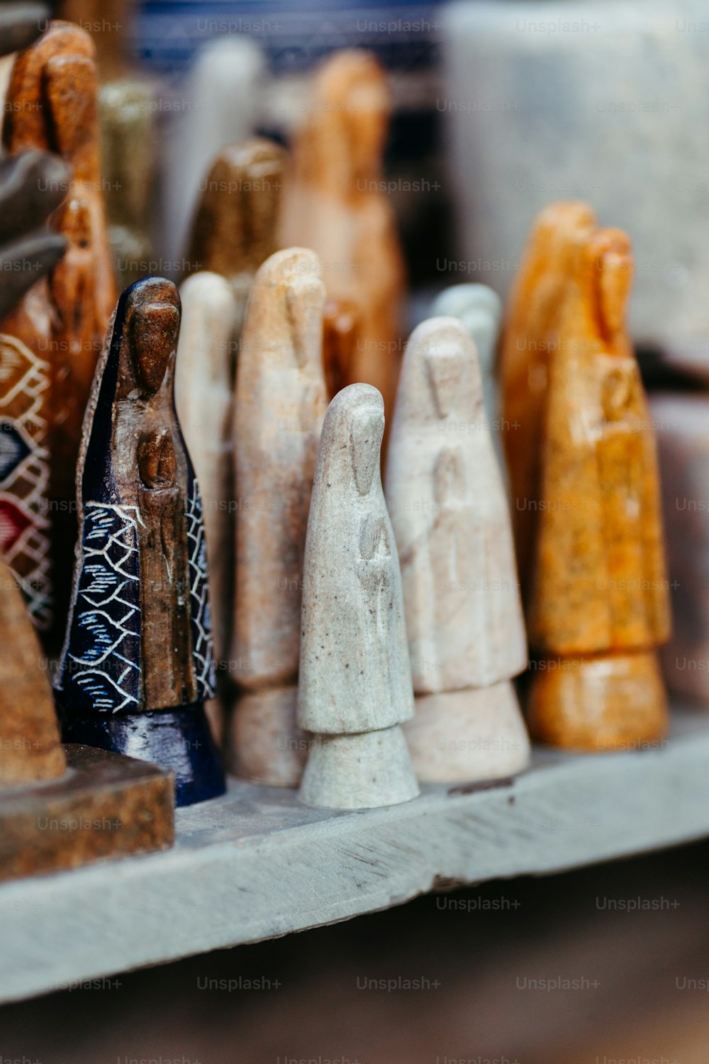 a group of wooden figurines sitting on top of a shelf