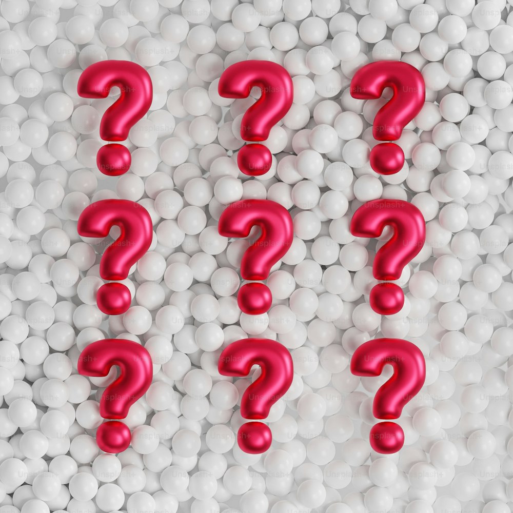 a group of red question marks surrounded by white balls