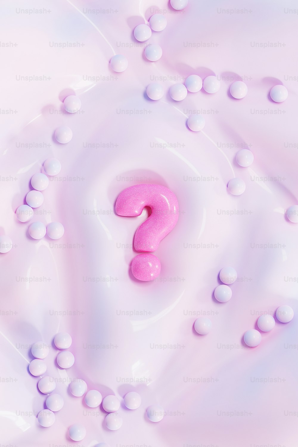 a pink question mark on a white surface