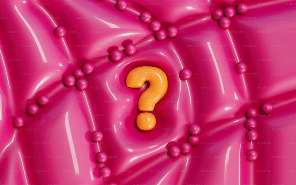 a yellow question mark on a pink background