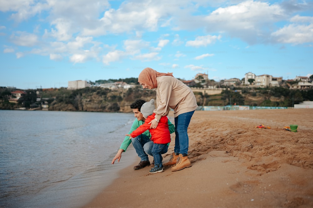a woman and two children on the beach