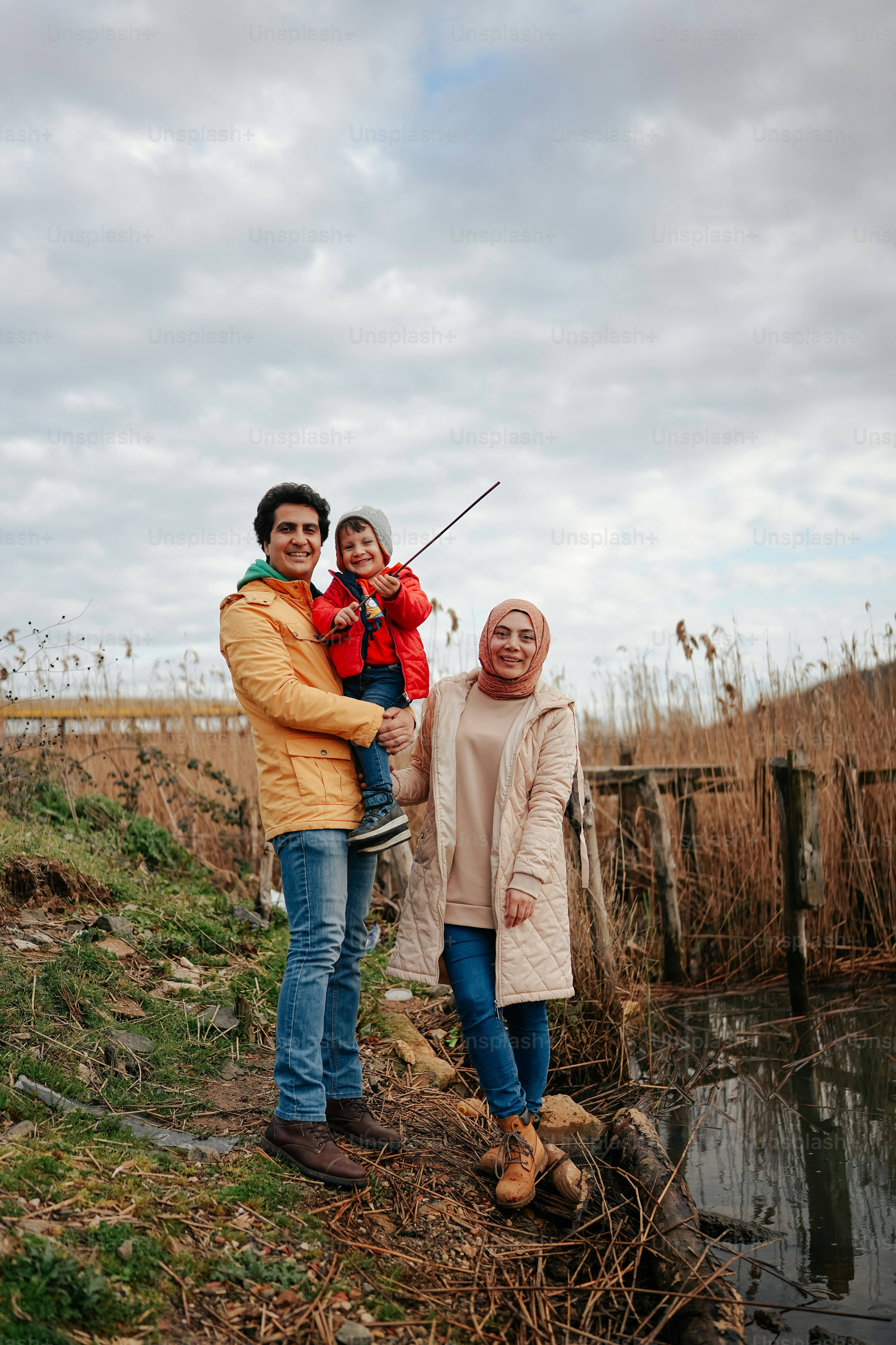 two women and a child standing in a field