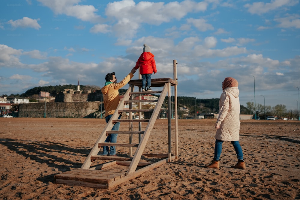 a group of people standing on top of a wooden ladder