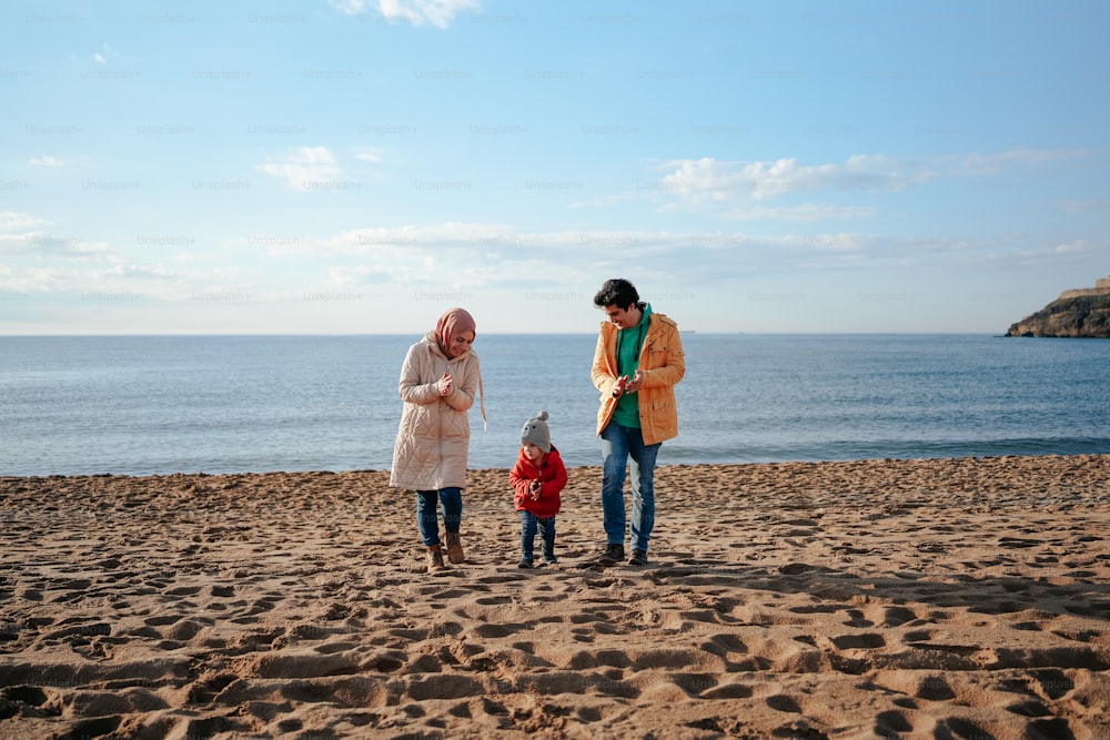 two women and a child standing on a beach