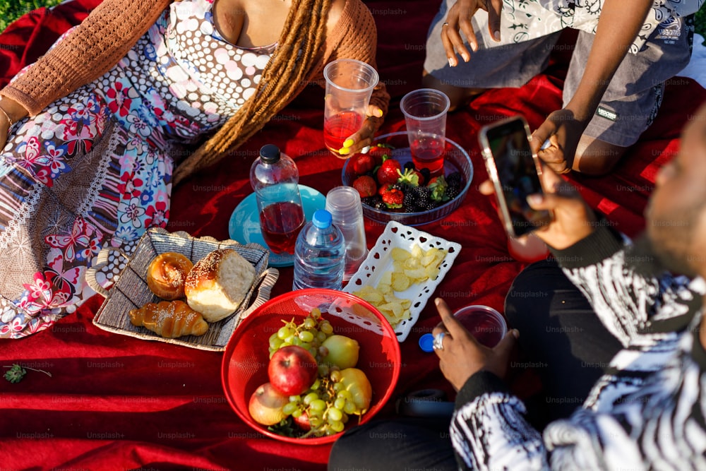 a group of people sitting around a table with food
