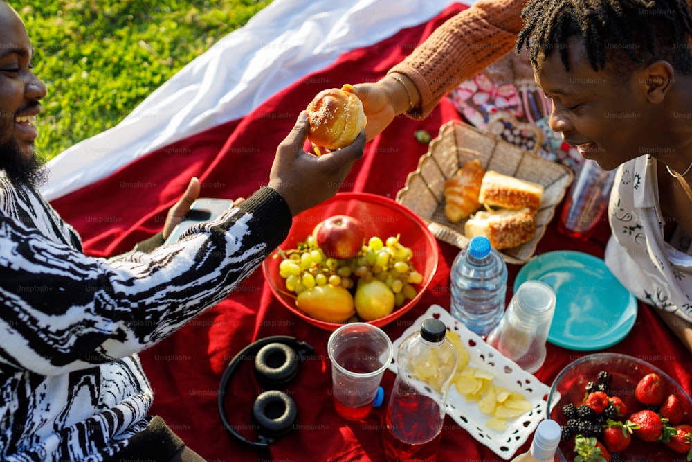 a couple of people that are sitting on a blanket