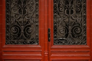 a close up of a red door with wrought iron