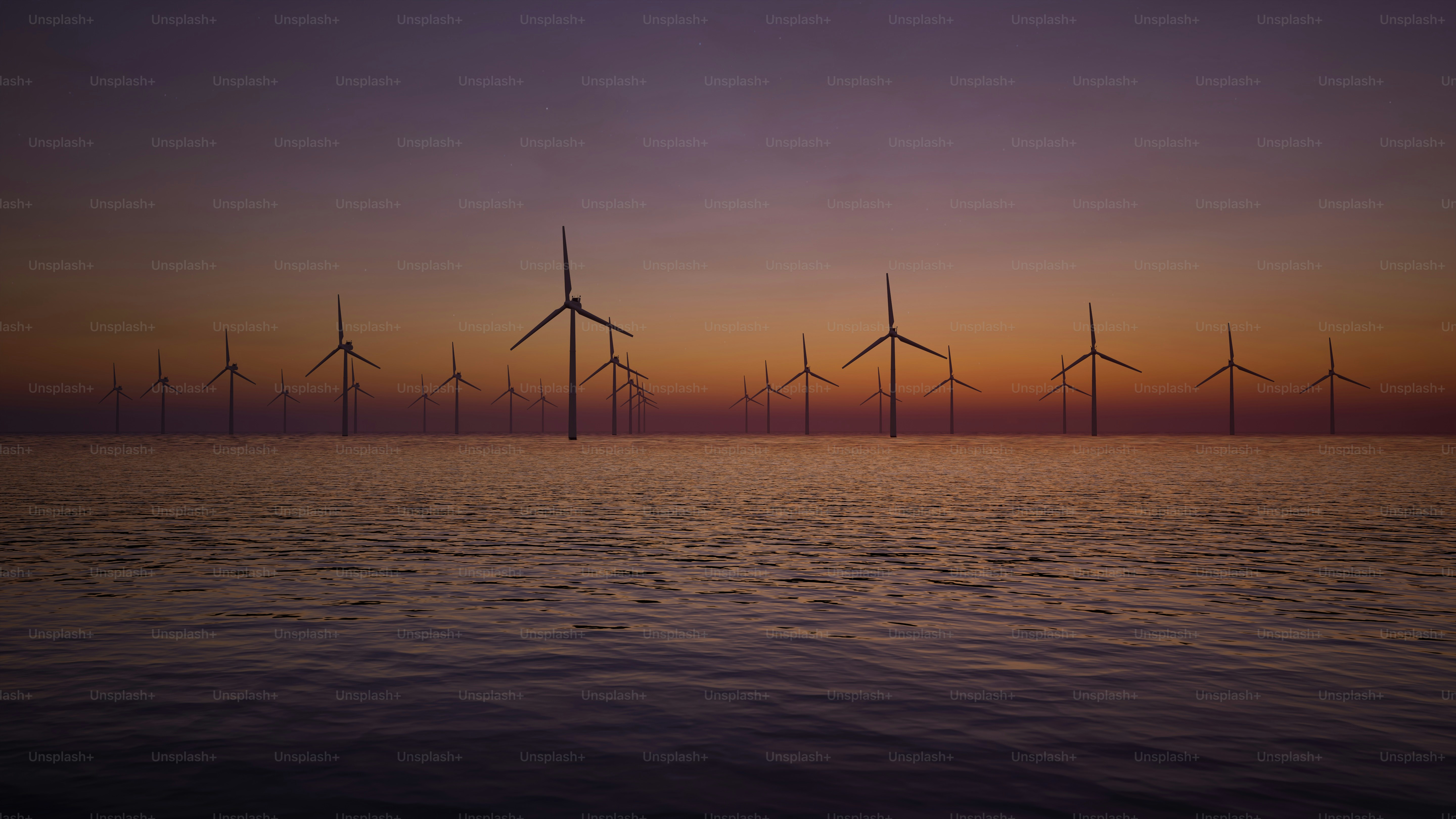 Eine Gruppe von Windmühlen im Meer bei Sonnenuntergang