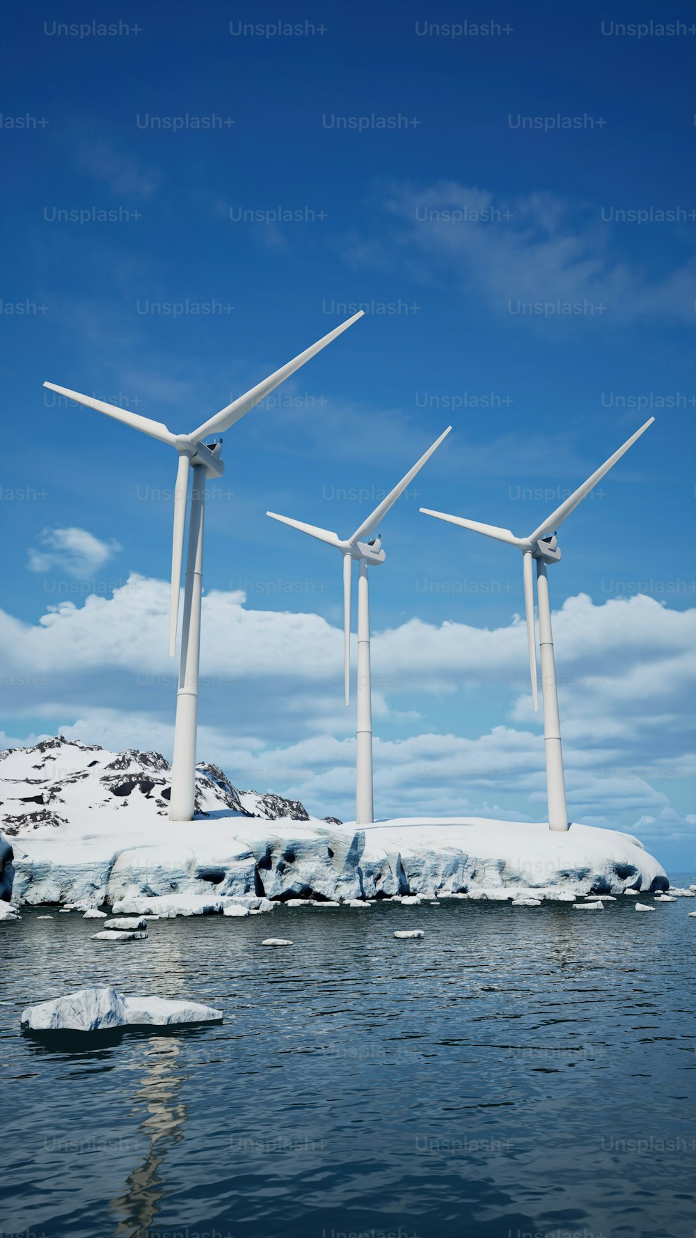 eine Gruppe von Windkraftanlagen, die auf einer schneebedeckten Insel stehen