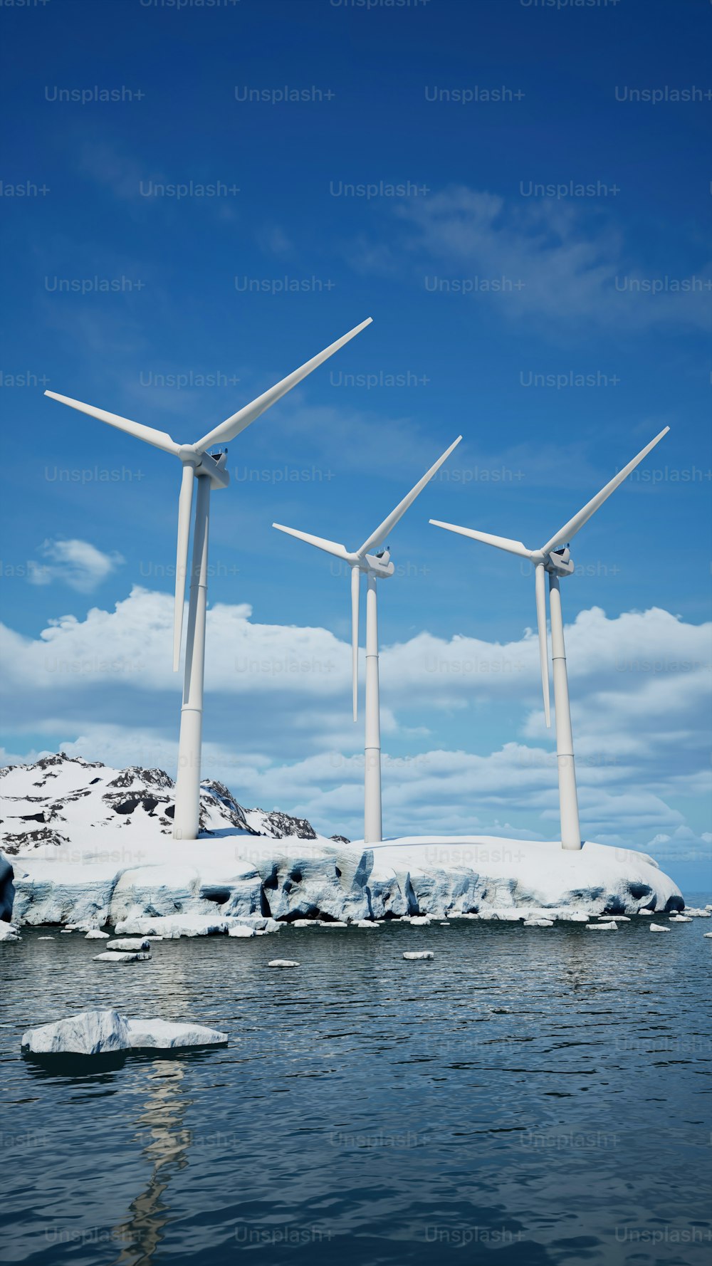 a group of wind turbines standing on top of a snow covered island