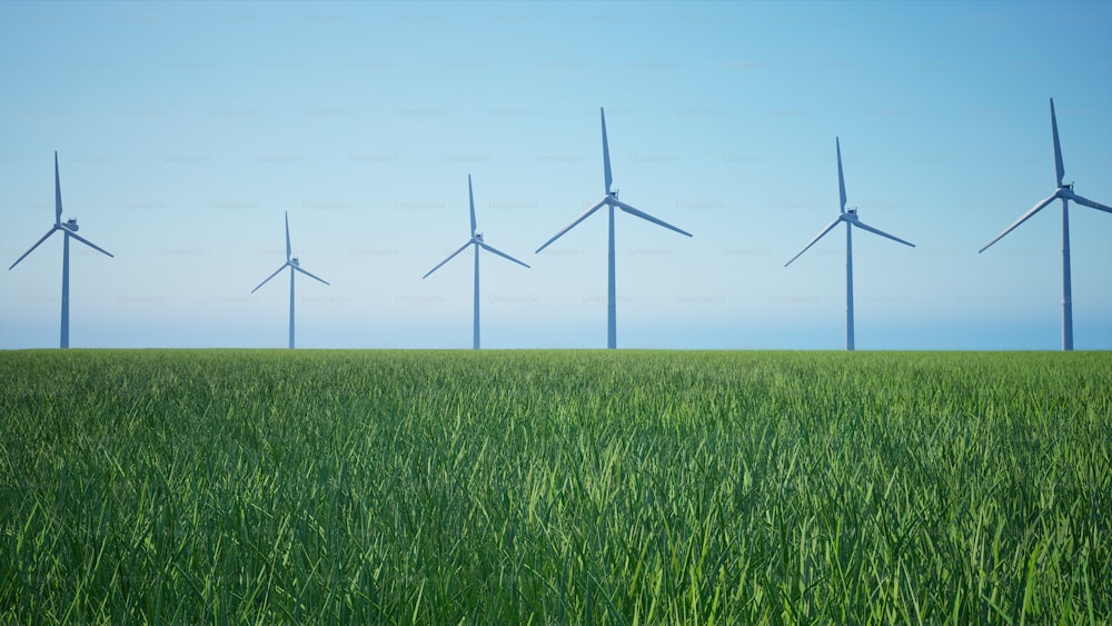Una hilera de turbinas eólicas en un campo verde