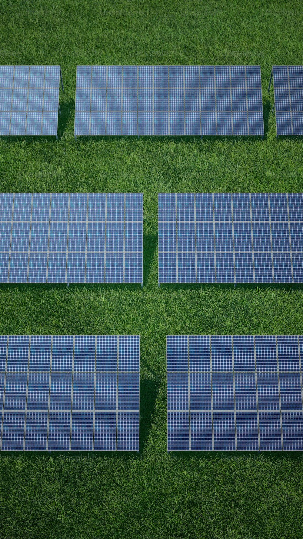 a group of solar panels laying on top of a lush green field