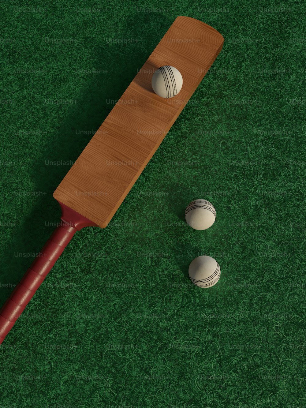 a wooden paddle and two white balls on a green surface