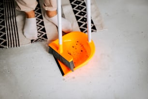 uma pessoa está limpando o chão com uma vassoura