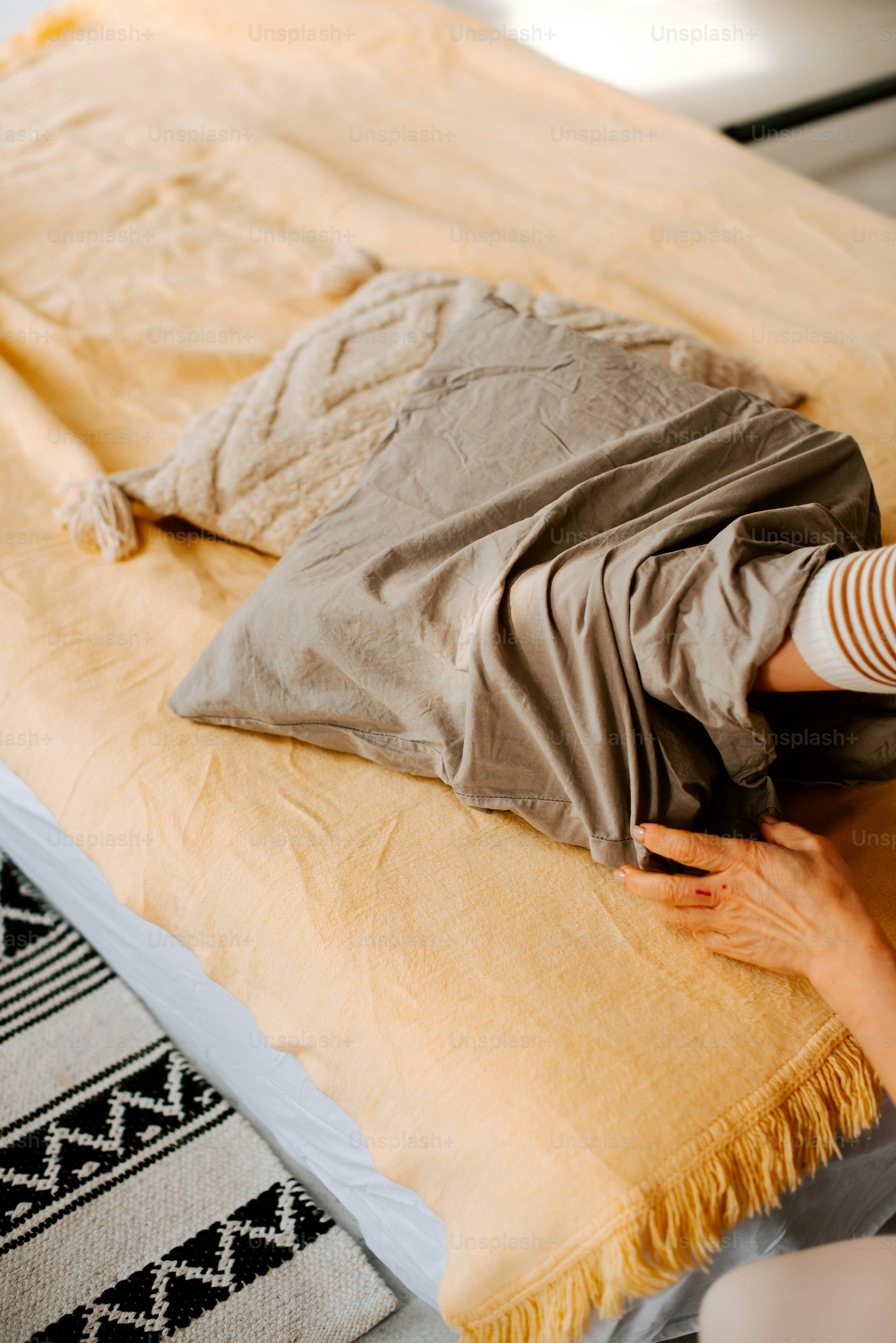 毛布でベッドに横たわる人