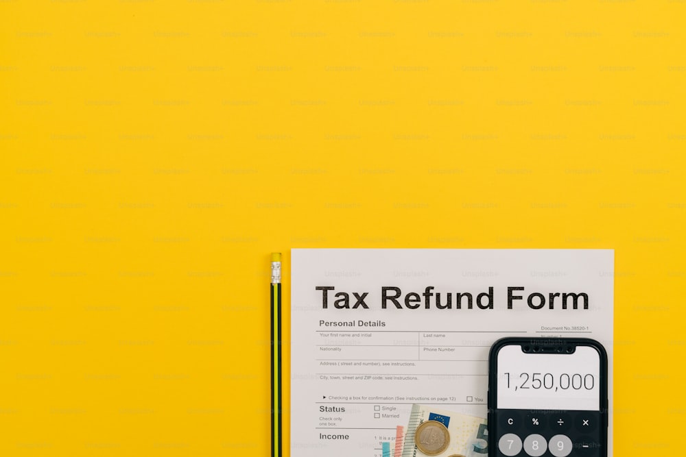 a tax refund form next to a calculator and pencil
