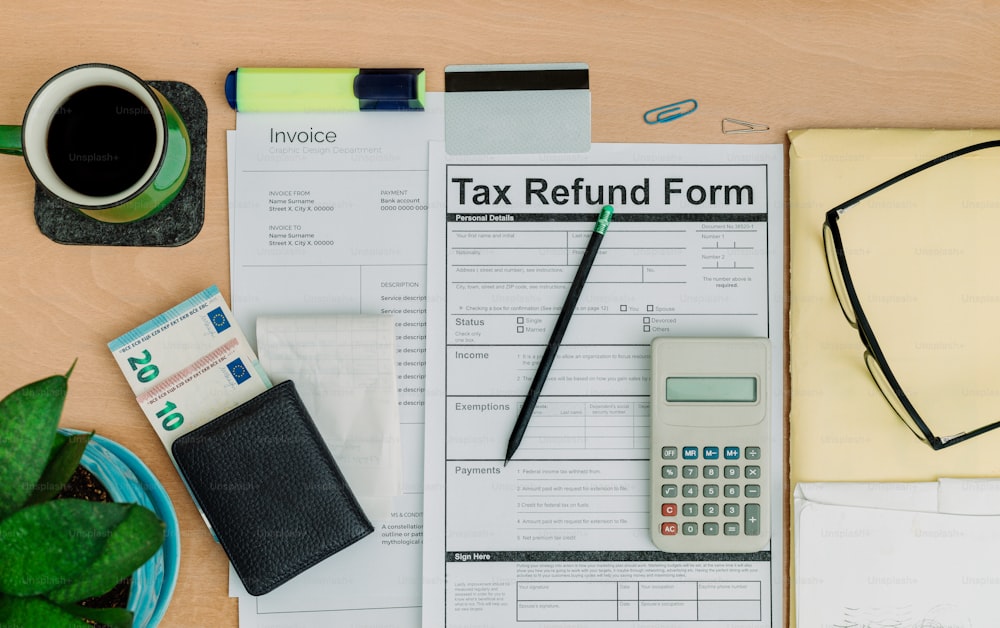 a tax refund form sitting on top of a desk next to a cup of