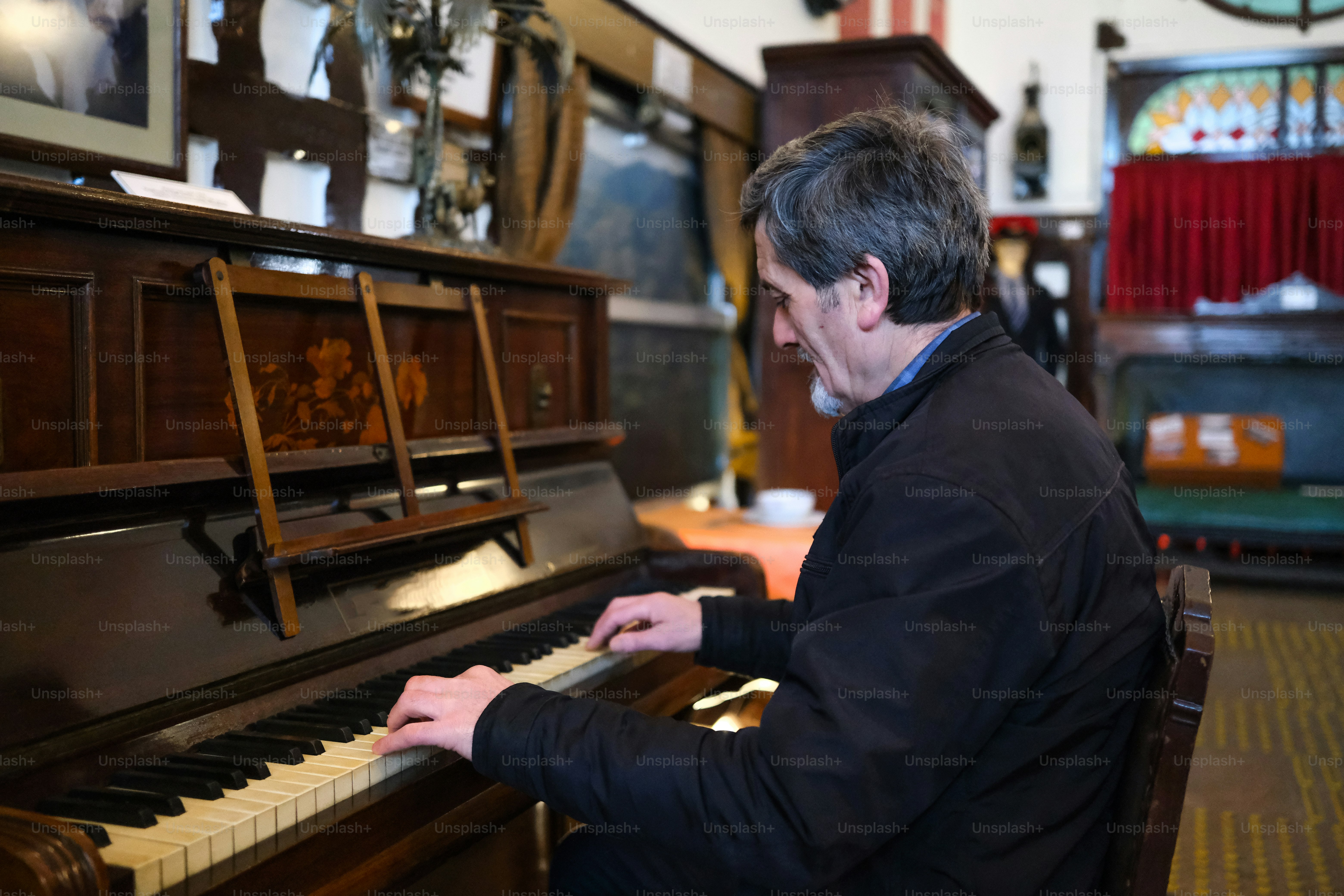 Ein Mann sitzt an einem Klavier in einem Raum