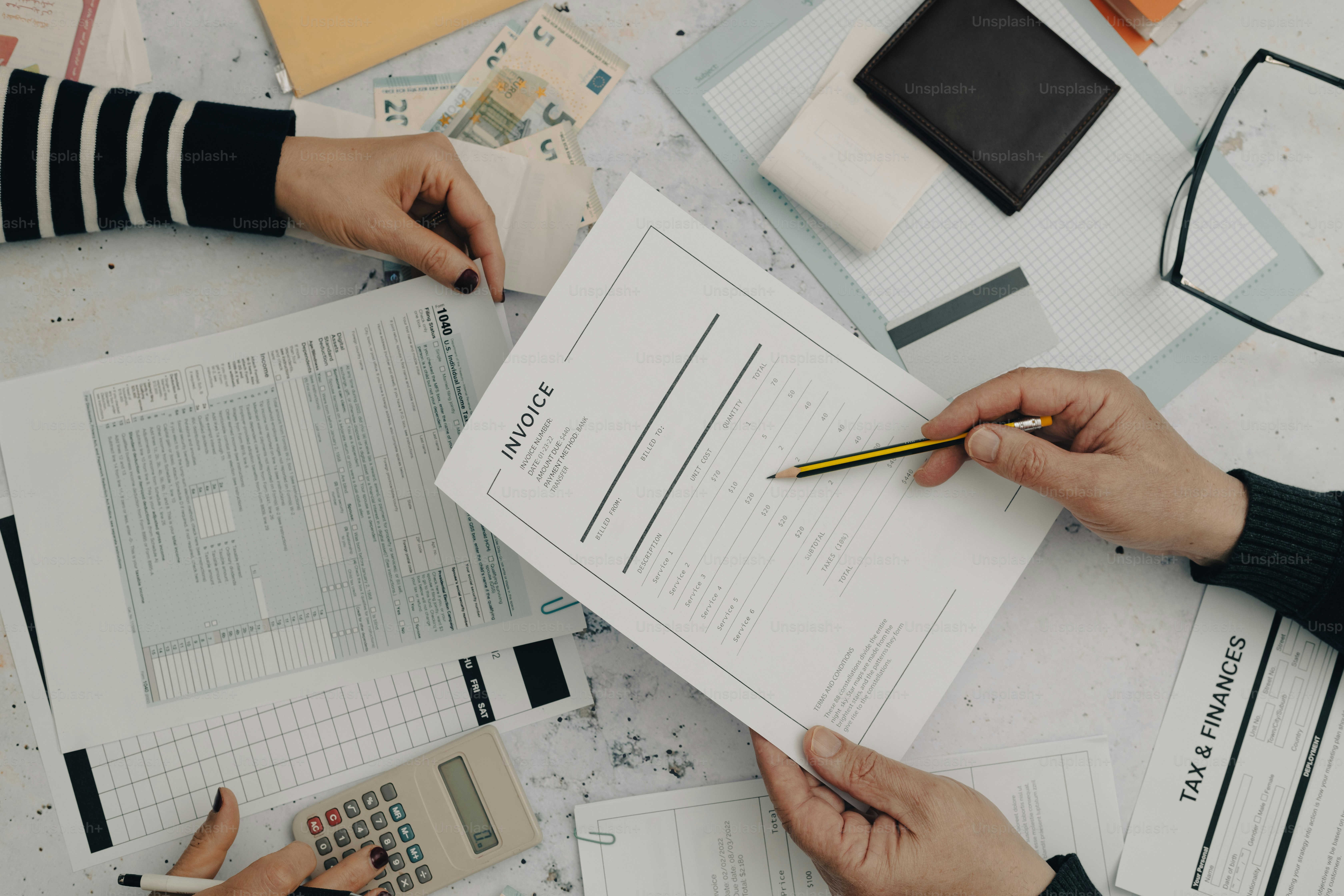 two people working on a project with a calculator and a calculator