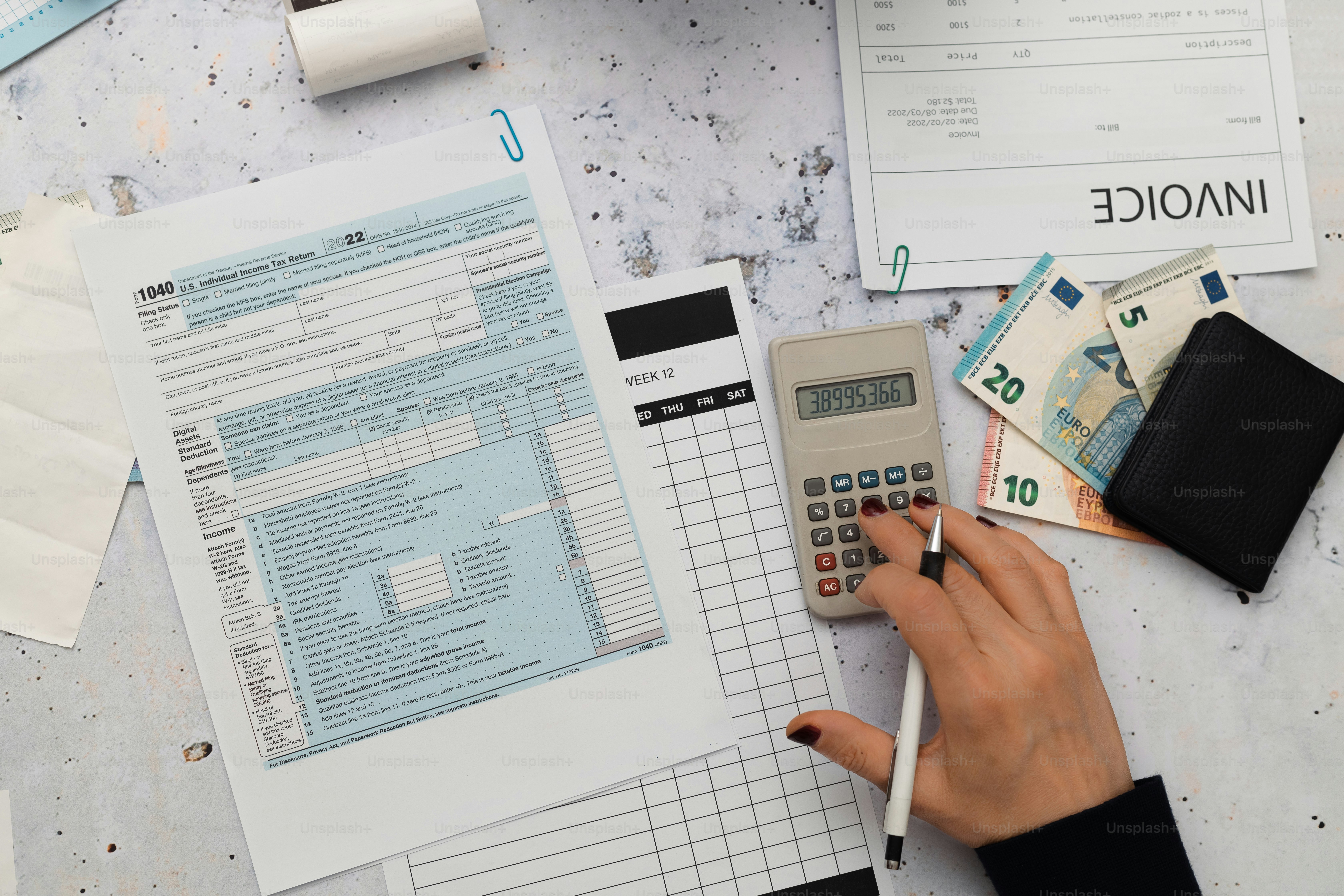 a person using a calculator on top of a table