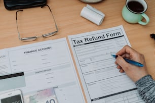 a person filling out a tax return form